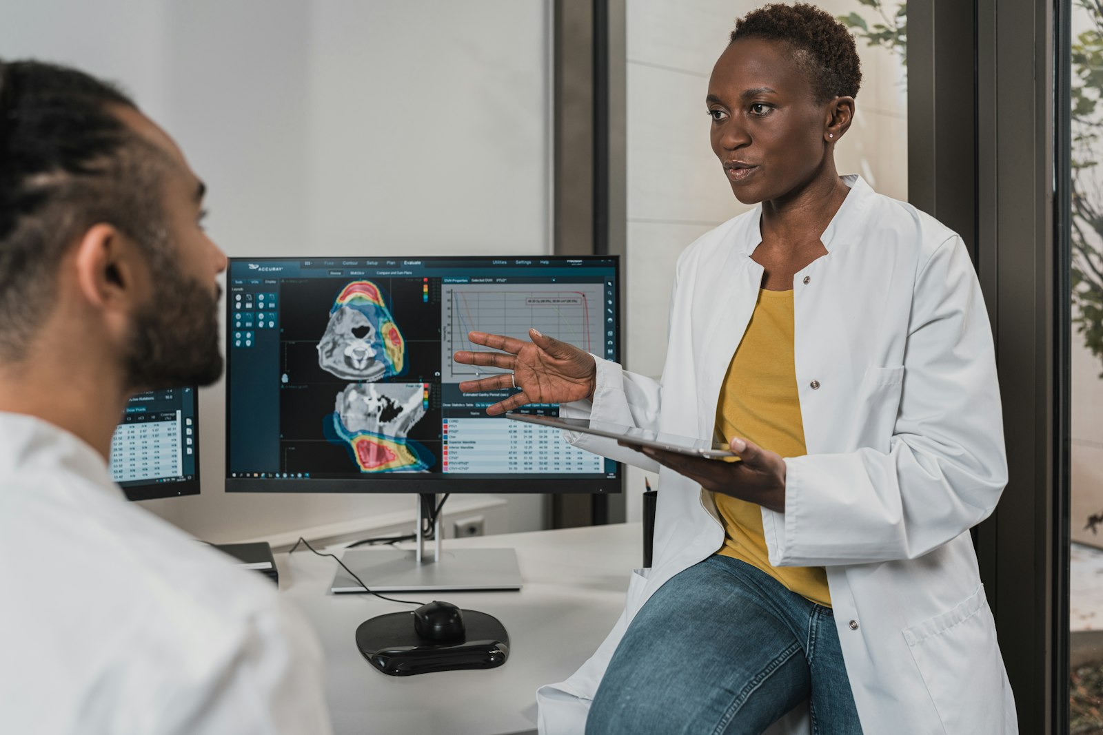 Two clinicians reviewing medical imaging together on a screen